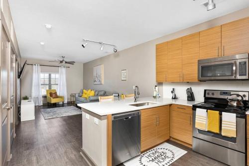 a kitchen with a sink and a stove top oven at 1Br Uptown, Pool, Wine, near Convention Center_311 in Charlotte