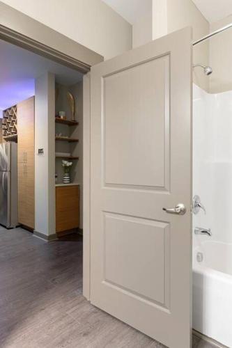 a white door in a room with a hallway at 1Br Uptown, Pool, Wine, near Convention Center_311 in Charlotte