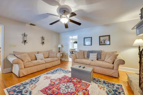 a living room with two couches and a ceiling fan at Blairsville Cabin with Hot Tub on Nottely Lake! in Blairsville