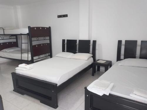 a room with three bunk beds in a room at Hotel Mileniun Valledupar in Valledupar