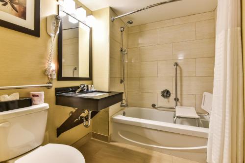 a bathroom with a tub and a sink and a toilet at Comfort Inn in Windsor