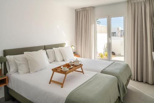 a bedroom with a large bed with a table on it at Nazaret Beach - Adults only in Arrecife