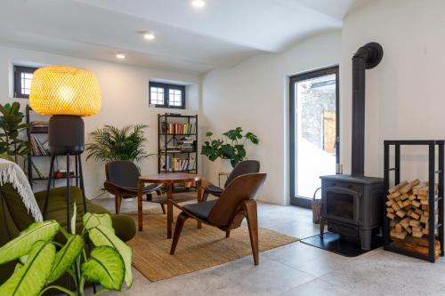 a living room with a wood stove and chairs at Gonna Dom w Górach in Gniewoszów
