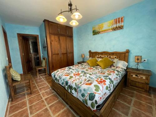 a bedroom with a bed in a blue room at Moradas Portilla in Portilla de la Reina
