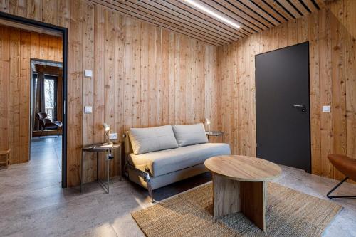 a living room with a couch and a table at Gonna Dom w Górach in Gniewoszów