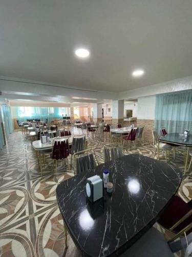 a banquet hall with tables and chairs in a room at Hotel Georgia in Gonio