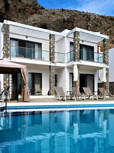 a villa with a swimming pool in front of a house at Villa Vitabel sea view in Lindos in Lindos