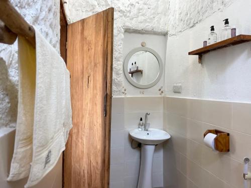 a bathroom with a sink and a mirror at HA Beach Hotel Zanzibar in Jambiani