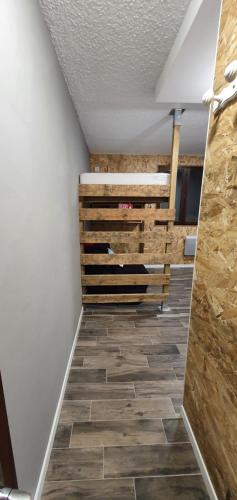 a hallway with a wooden bench and tile floor at La croix haute in Uvernet-Fours