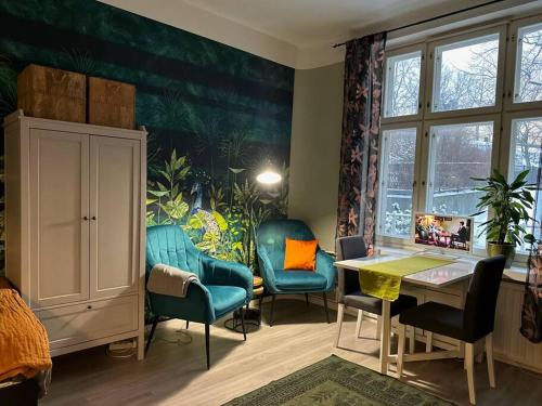 a room with chairs and a table and a window at Boutique Studio in the city in Helsinki