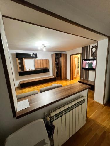 a living room with a large mirror on the wall at Debo Apartament in Lugoj