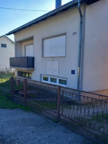 a building with a fence in front of it at Shalom Krašić in Krašić