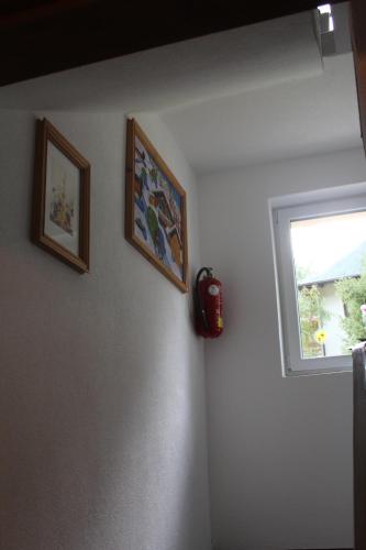 a room with two pictures on the wall and a window at Aktivurlaub Morandell in Sölden