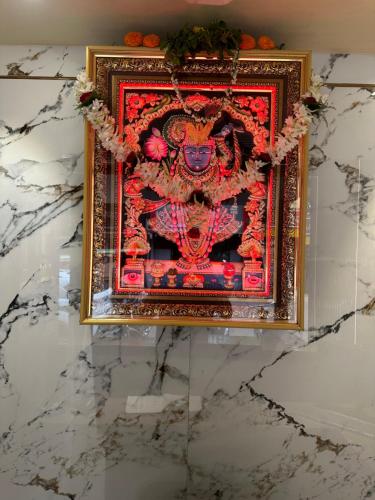 a picture of a painting of a deity on a wall at Hotel Vinayak in Kharagpur