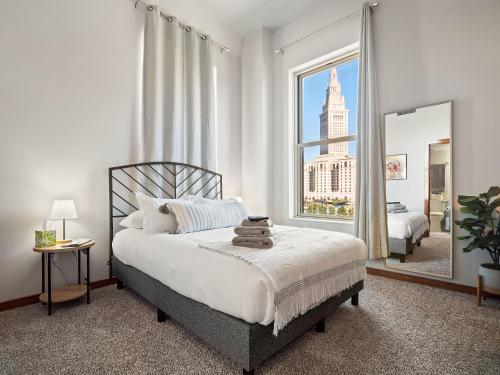 a bedroom with a bed and a large window at Downtown Condo in Cleveland