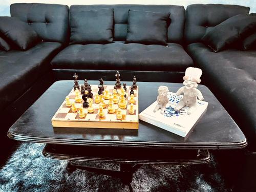 a chess set on a table in front of a couch at Titos Centric Home in Morelia