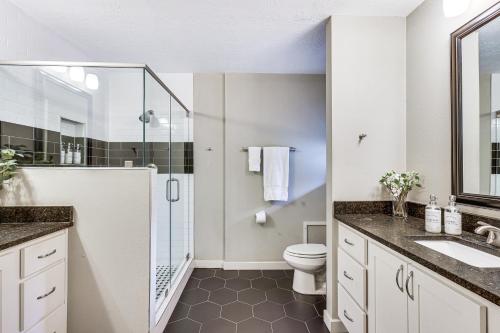 a bathroom with a toilet and a glass shower at Spacious Bryan Home with Patio 4 Mi to Downtown in Bryan