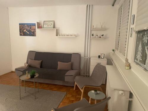 a living room with a couch and two chairs at Apartman Vuković in Novi Beograd
