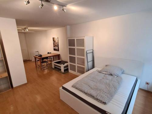 a bedroom with a bed and a desk in it at City Central Apartment in Kaiserslautern