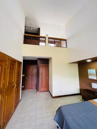 an empty room with a bed and some wooden doors at The Rainier Bed & Breakfast 5 in San José
