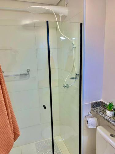 a shower with a glass door in a bathroom at Studio Vertentes in Sao Paulo
