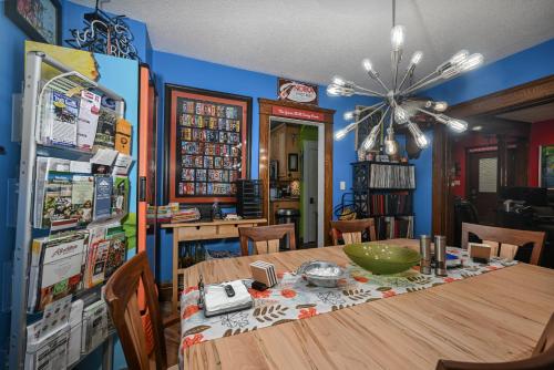 a dining room with a wooden table and a refrigerator at Berrodin Bed & Breakfast in Akron