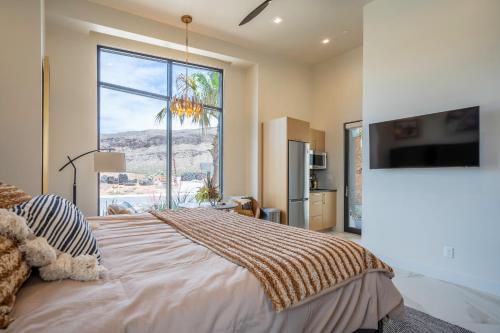 a bedroom with a large bed with a large window at Live Luxurious at Zion in Hurricane