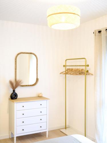 a bedroom with a dresser and a mirror at OASIS - 10 min from Disney, Free Parking, Self-Checkin in Montévrain