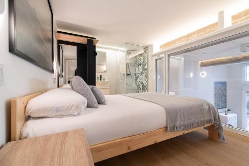 a bedroom with a large bed and a window at Loft Playa Samil in Vigo