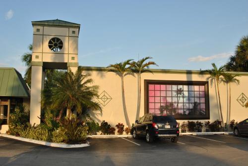 a car parked in a parking lot in front of a building at Floridian Hotel in Homestead