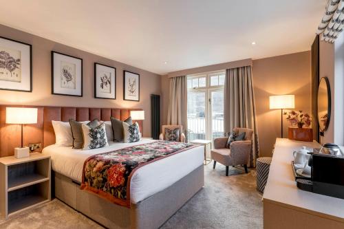 a hotel room with a bed and a desk at Borrowdale Gates Hotel in Keswick
