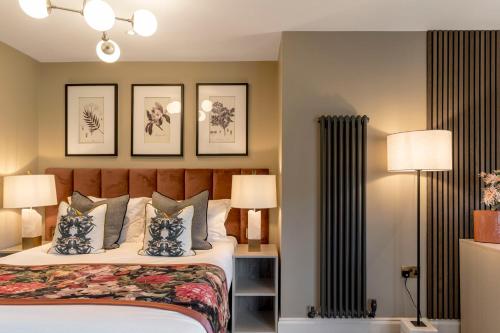 a bedroom with a bed and three pictures on the wall at Borrowdale Gates Hotel in Keswick