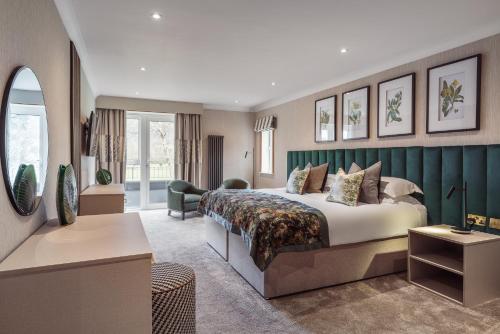 a hotel room with a bed and a living room at Borrowdale Gates Hotel in Keswick