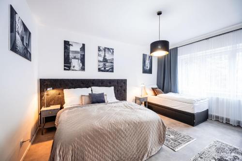 a bedroom with a large bed and a couch at Silvie Apartments - Lazecká in Olomouc