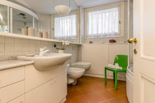 bagno bianco con lavandino e servizi igienici di VillaColdiLunaProseccoHills 