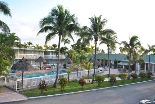 a view of a resort with a pool and palm trees at Floridian Hotel in Homestead