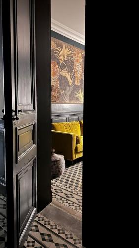 a view of a room with a yellow couch at Maison d'Hôtes " L'INSTANT D'AILLEURS" in Albi
