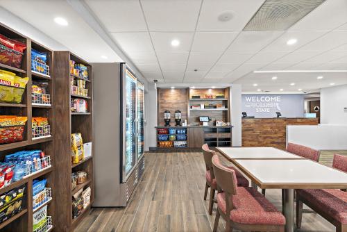 a waiting area in a pharmacy with a table and chairs at Hampton Inn Los Angeles Airport in Los Angeles