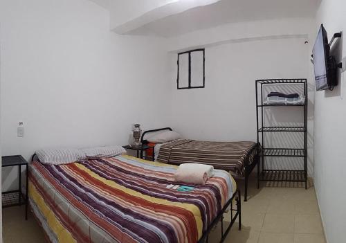 Postel nebo postele na pokoji v ubytování Hostal Los Faroles Chicoana