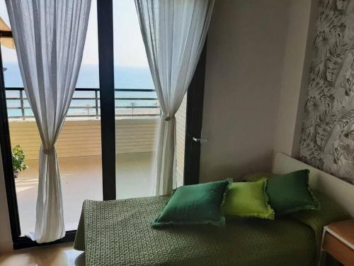a living room with a couch and a large window at Top-Floor Beachfront Apartment with Parking, Pool, & Beautiful Sea-View Balcony in Villajoyosa