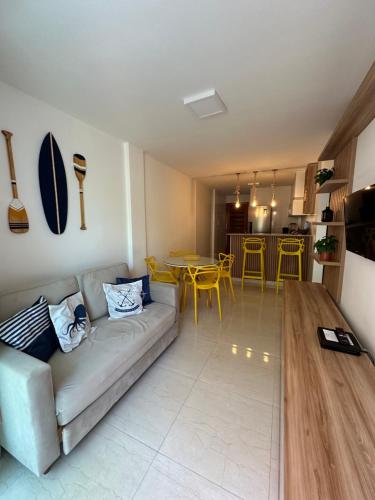 a living room with a couch and a table at Flat Porto do Galo in Porto De Galinhas