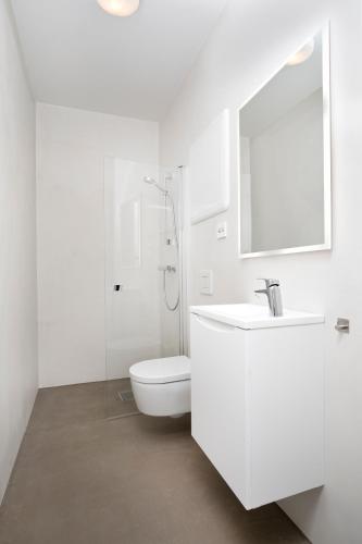 a white bathroom with a toilet and a sink at Central Guest House - Bedroom with en suite Bathroom in Stavanger