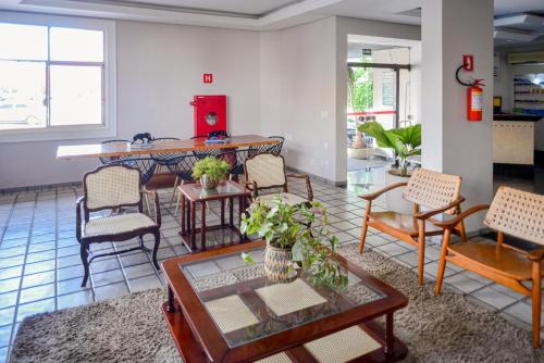 a living room with chairs and a table at Honorato Hotel in Rio Verde
