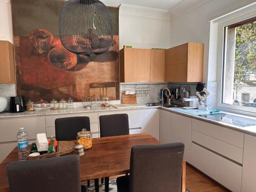 a kitchen with a wooden table and chairs in it at Appartamento con terrazza centrale e luminoso in Rome