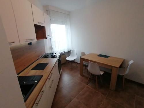 a kitchen with a wooden table and a table and chairs at Central Apartment no2. in Zagreb
