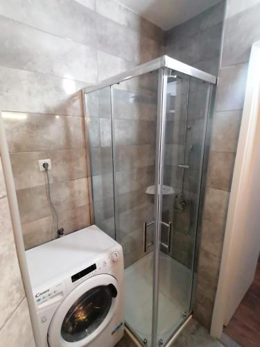 a washing machine in a bathroom with a shower at Central Apartment no2. in Zagreb