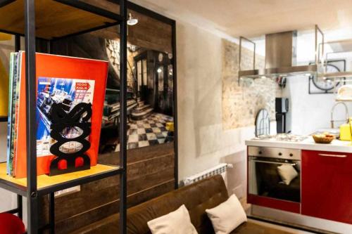 a kitchen with a couch and a kitchen with a stove at La Casa dello Stilista in Brescia