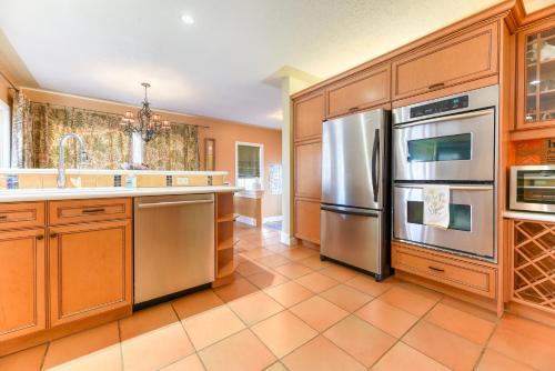 a kitchen with wooden cabinets and stainless steel appliances at First Place in Strathmore