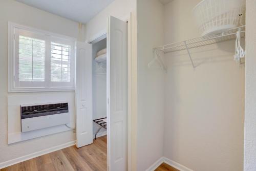 a room with a closet with a window at Tequesta Palms Inn in Tequesta