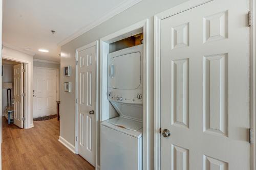 a white laundry room with a washer and dryer at North Topsail Beach Condo in Resort-Style Complex! in North Topsail Beach